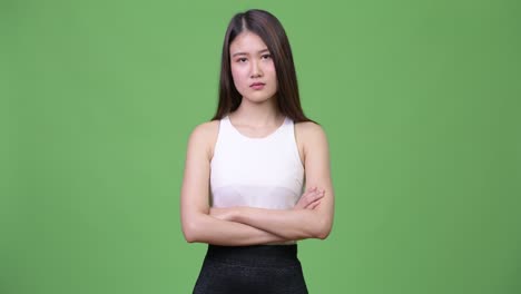 young beautiful asian businesswoman with arms crossed