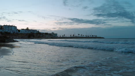 beautiful wide beach drone shot on low tide wet sand reflecting sky during sunset