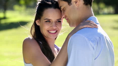 Loving-couple-standing-in-the-park-