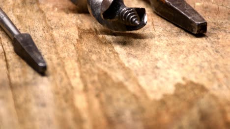 old drillbits on wooden table in woodshop