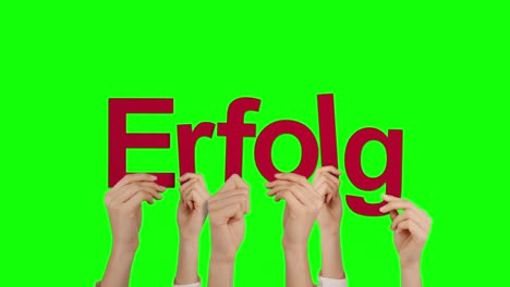 Woman-hand-holding-word-ERFOLG