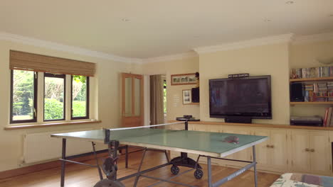 right to left pan of a family games room in a rural home in slow motion