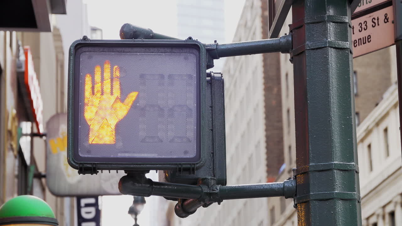 Pedestrian Walk Signal Turning From Orange Hand Stop To Walk In Daytime New York City. Slow Motion.