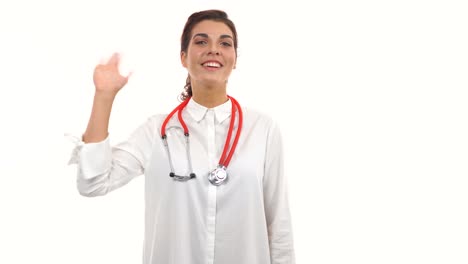 Smiling-female-doctor-waving-her-hand,-crossing-arms-and-looking-at-camera.-Portrait-of-young-medical-professional-with-stethoscope-and-lab-coat-isolated-on-white-background