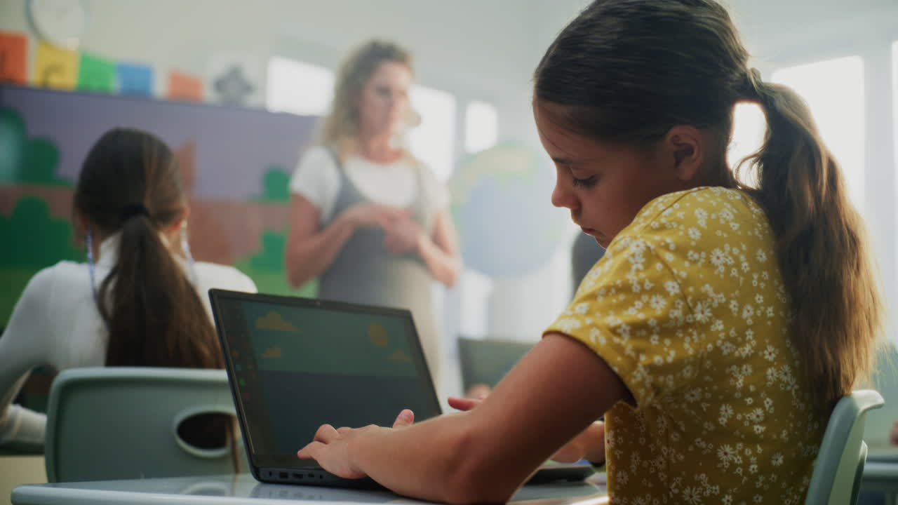 Female Teacher Guiding Young Kids During Art Lesson Using Digital Screen