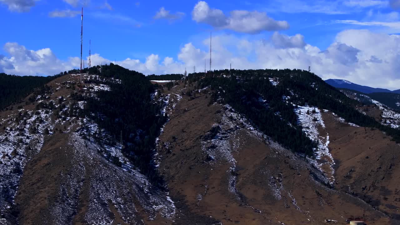 Snowy Lookout Mountain Genesse Morrison Golden Evergreen aerial drone view Colorado power line towers winter sunny morning afternoon Buffalo Bills Grave blue sky clouds circle right motion