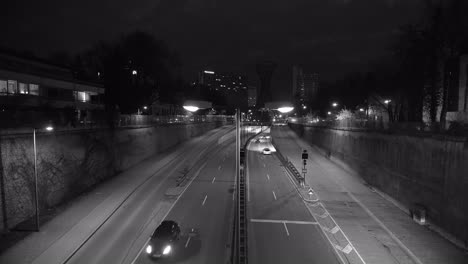 Rush-hour-at-the-night-in-Munich-city-in-black-and-white-with-car-traffic-of-a-street-with-many-tracks-in-both-directions