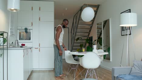 man working from home in a modern kitchen-apartment