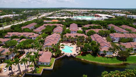 aerial: residential area and real estate during the day in west palm beach, florida, usa, crane up drone shot
