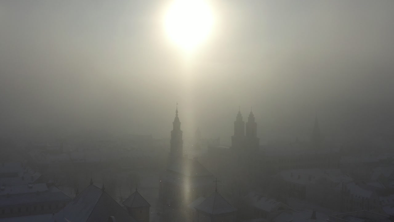 Cold winter sunrise in Kaunas old town. Snow and sun. Lithuania