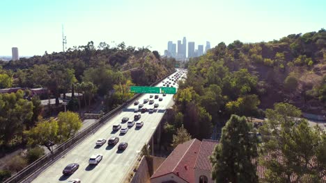 aerial freeway cars travel along the 110 freeway in los angeles through tunnels and towards downtown skyline 2