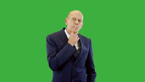 a pensive businessman deep in thought thinking of a solution to a business problem with green screen background