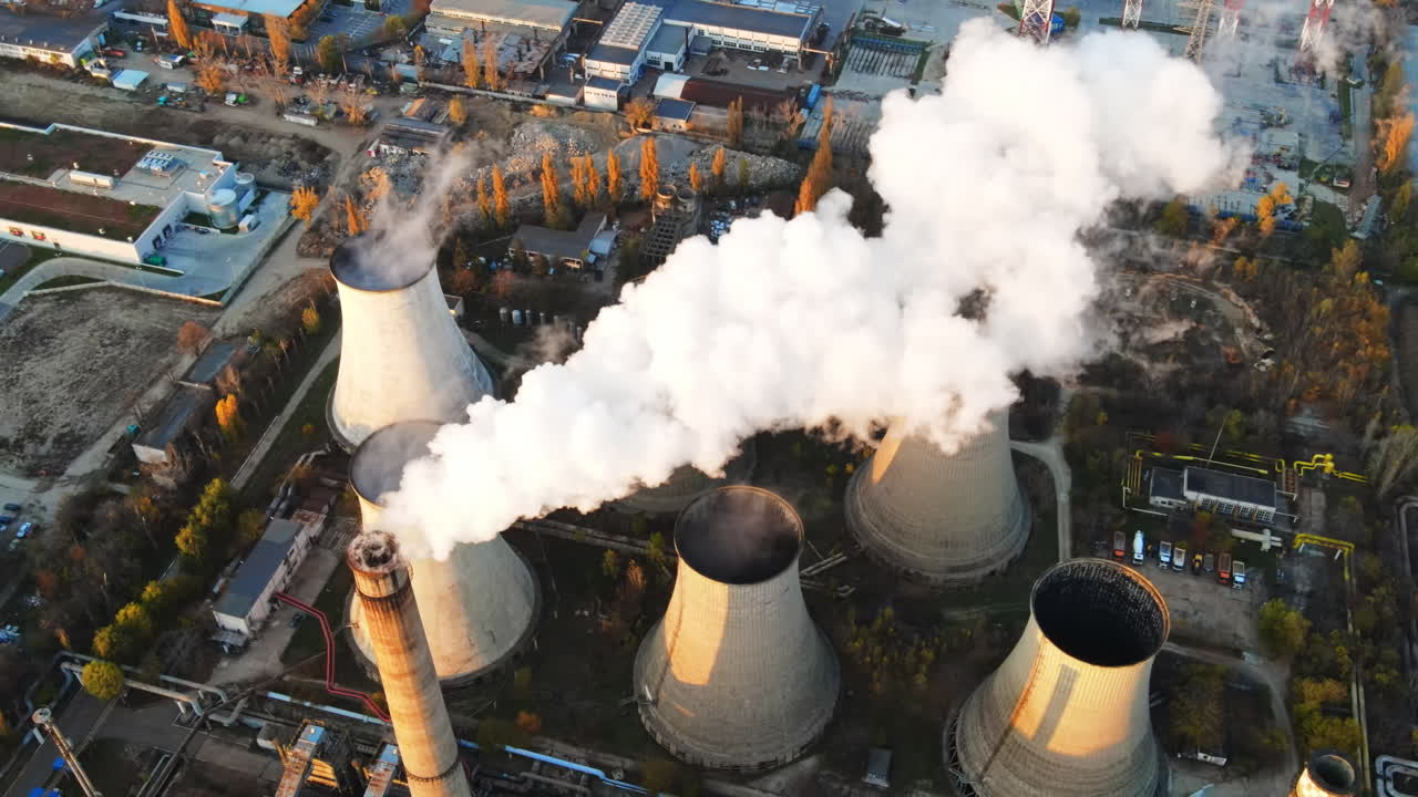 Power station with a lot of tubes and facilities in Bucharest at sunset, a lot of foam, view from the drone, Romania