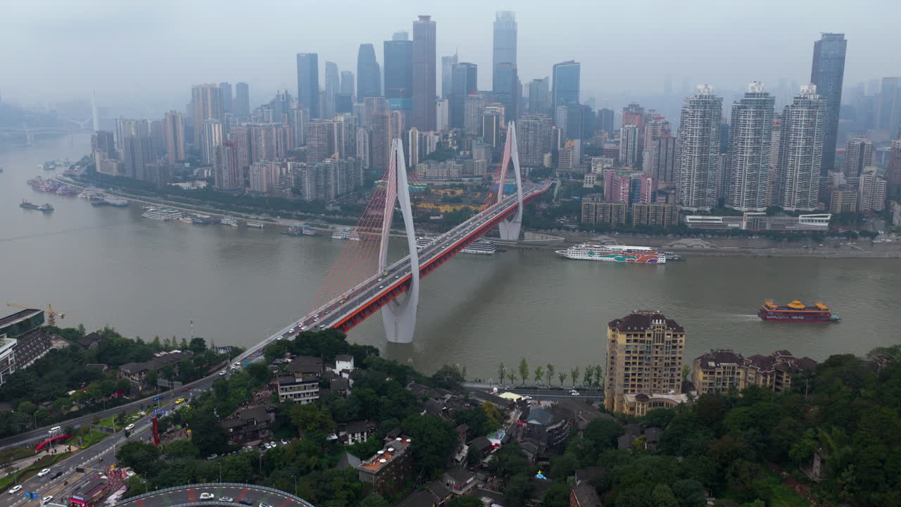 Dongshuimen Bridge Over Yangtze River And Yuzhong District Seen From Nan'An In Chongqing, China. - aerial shot