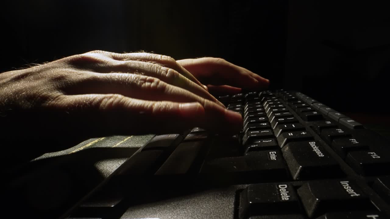 Man is typing on a keyboard.