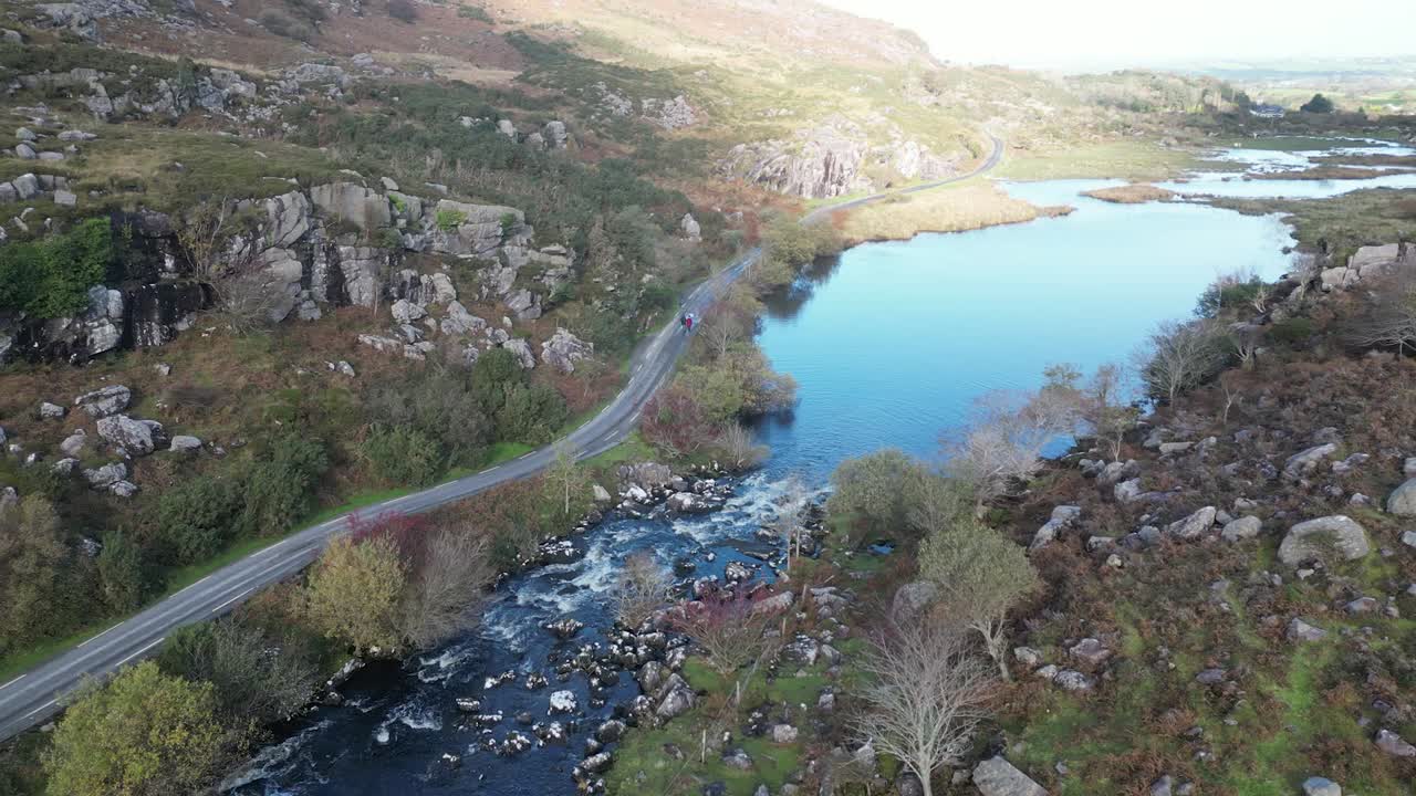 Wide panning aerial shot of Gap of Dunloe, Bearna or Choim&iacute;n, mountain pass in County Kerry, Ireland