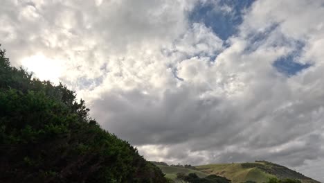 cloudy sky over lush green hills