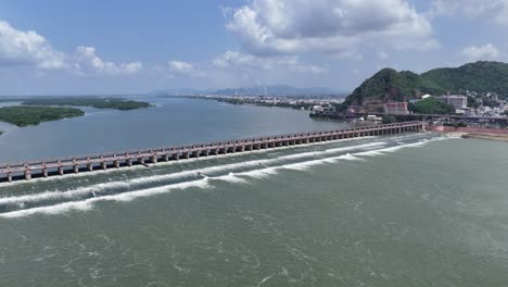 aerial drone shot of krishna river dam in vijayawada with mountain nearby