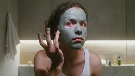 man applying clay mask