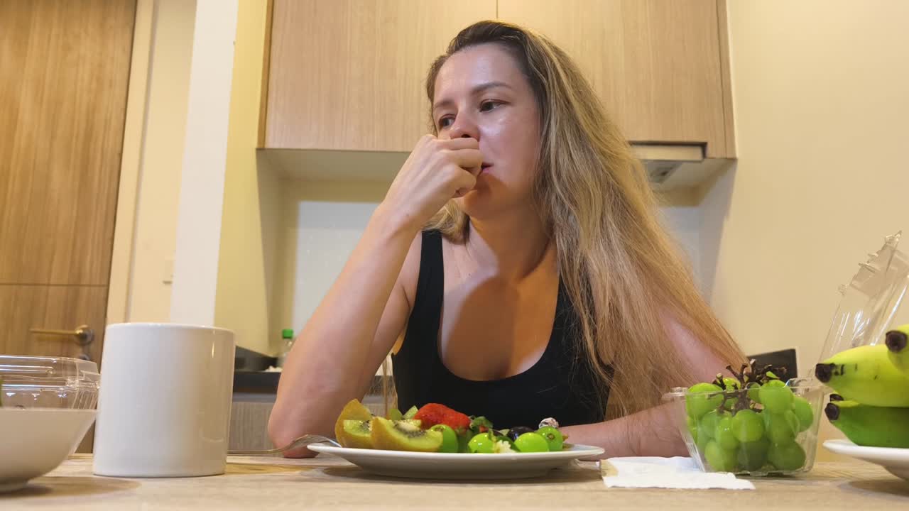 Woman eating fruit breakfast