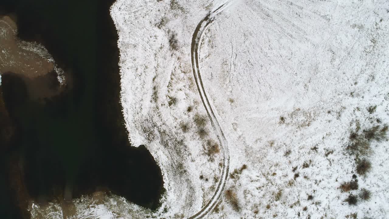 Road on the snow covered land along the river during winter 4k