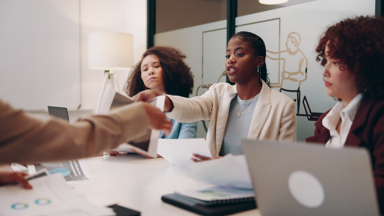 Three businesswomen have a meeting in an office