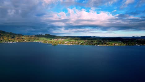 Breathtaking-aerial-view-of-a-turquoise-lake-surrounded-by-snow-capped-mountains