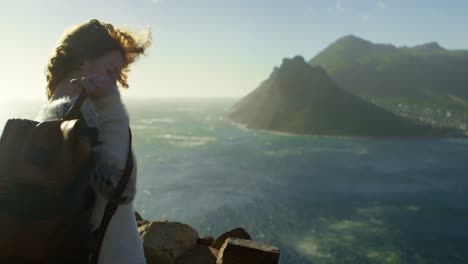 woman standing with backpack near a sea 4k