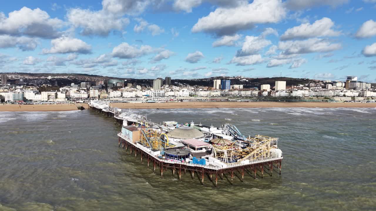 Ascending drone,aerial Brighton pier sunny day fluffy white clouds in background