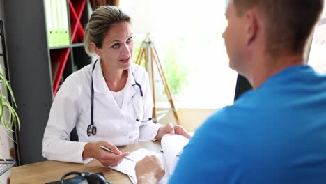doctor consulting with a male patient in a clinic office