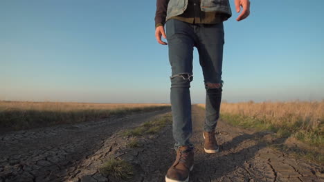 man walking down a country road