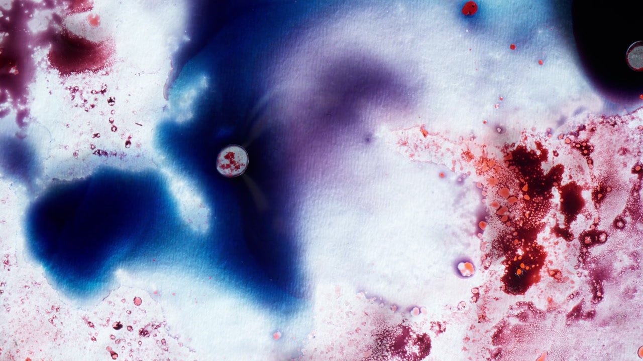 Vibrant blue and purple alcohol ink blend together in a cosmic swirl, representing galaxy formation or abstract emotions through fluid and color evolution.