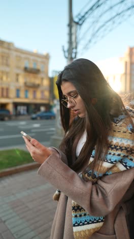 young woman using smartphone in city