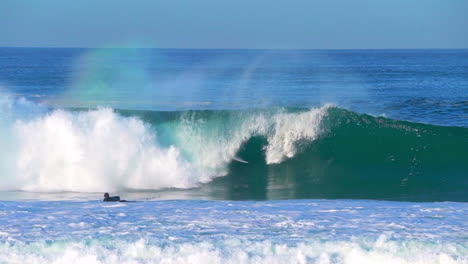 Cinematic-follow-pan-early-morning-surfers-going-left-barrel-huge-waves-glassy-swell-surf-Hossegor-Seignosse-France-yellow-sunrise-sunset-on-beach-mountain-grassy-sandy-coast-Biarritz-Basque-Country