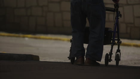 elderly person walking with walker at night