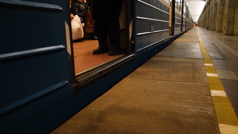 subway platform with train and passengers