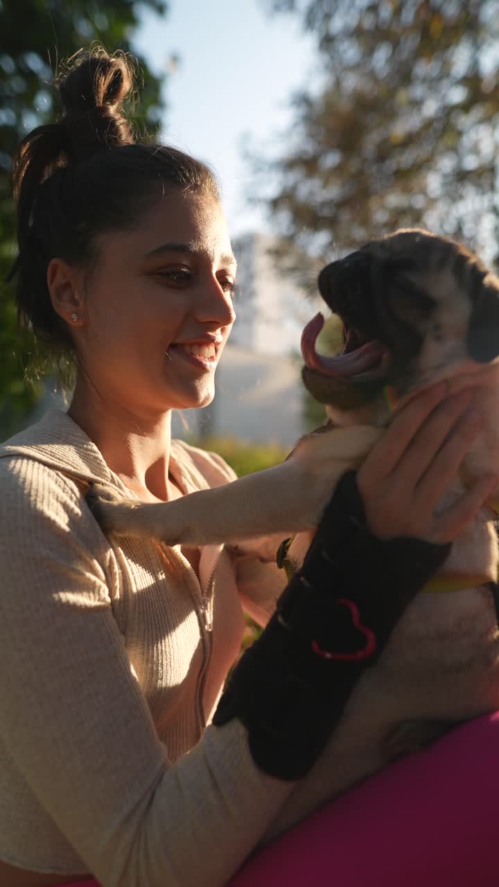 mujer y su pug en el parque