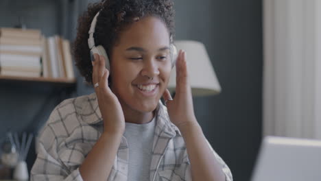 teenage girl enjoying music and studying online