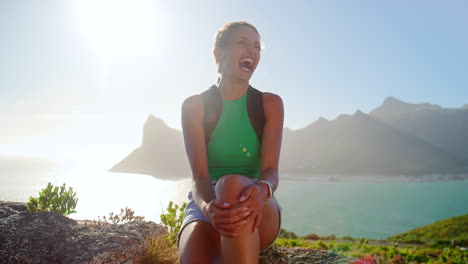 portrait of woman with backpack on vacation taking a break on hike by sea on coastal path