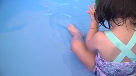 A-toddler-inside-a-pool-playing-with-toys