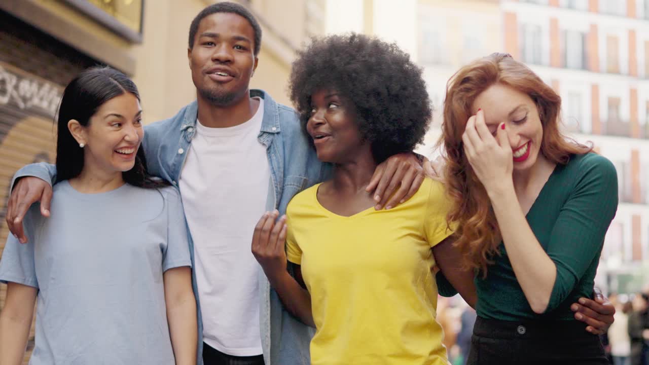 Happy Group of Diverse Friends Walking and Laughing Together on a City Street