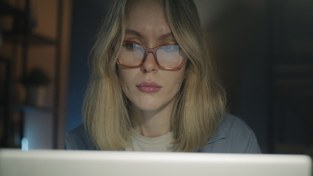 Woman working late night at home on laptop