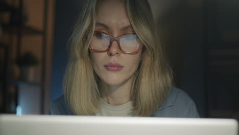 Woman working late night at home on laptop