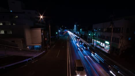 a night timelapse of the traffic jam at the city street in tokyo wide shot