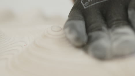 men sanding a piece of wood close-up