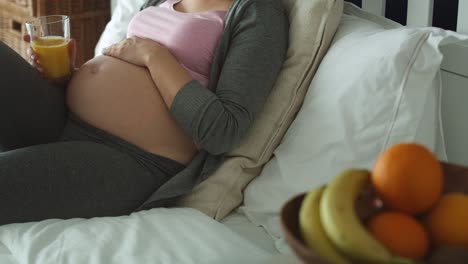 Video-of-pregnant-woman-and-bowl-of-fruits-in-the-foreground.