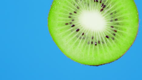 with ripe slices kiwi fruit falling a drop of juice.