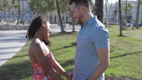 diverse kissing couple in park