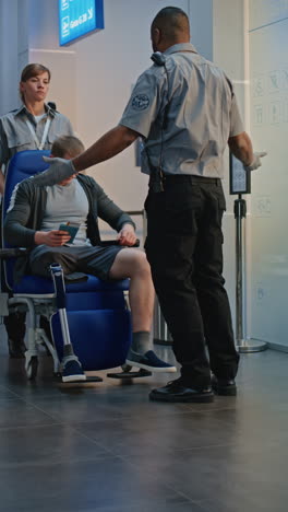 airport security check of passenger with prosthetic leg