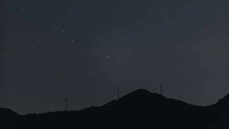 perseids meteor shower over wind turbines in the skyline